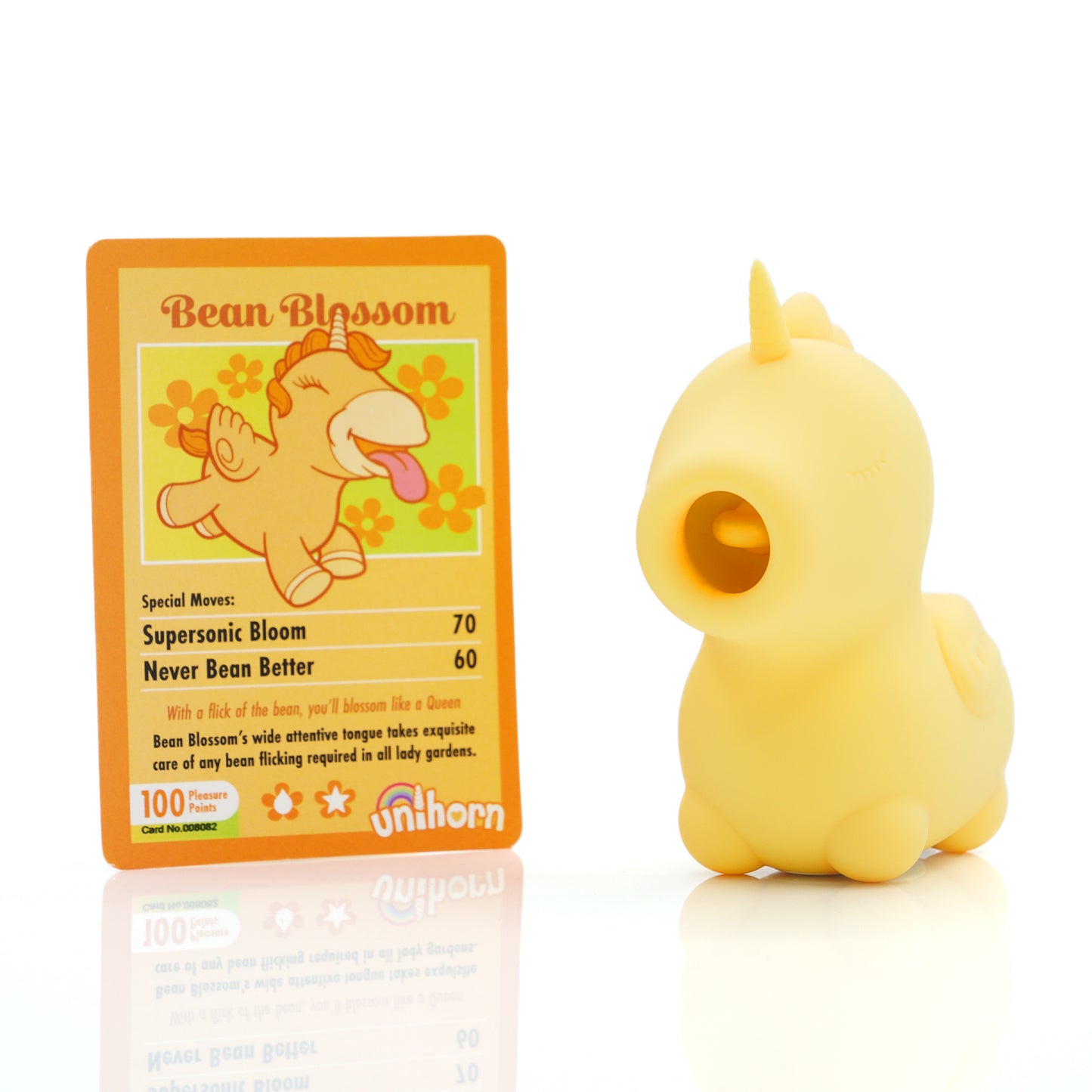Yellow Bean Blossom clitoral vibrator stood next to the yellow Blossom collectors card on a white background
