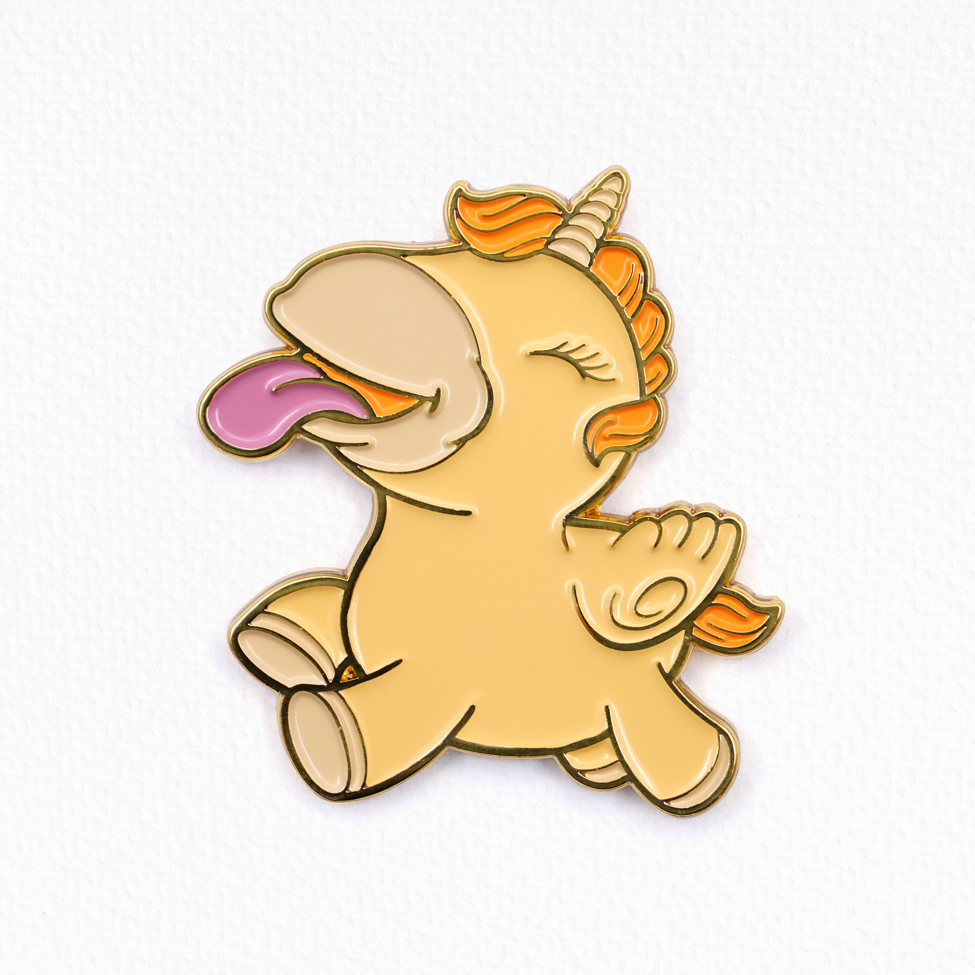 Yellow Bean Blossom Unihorn pin badge on a textured white background