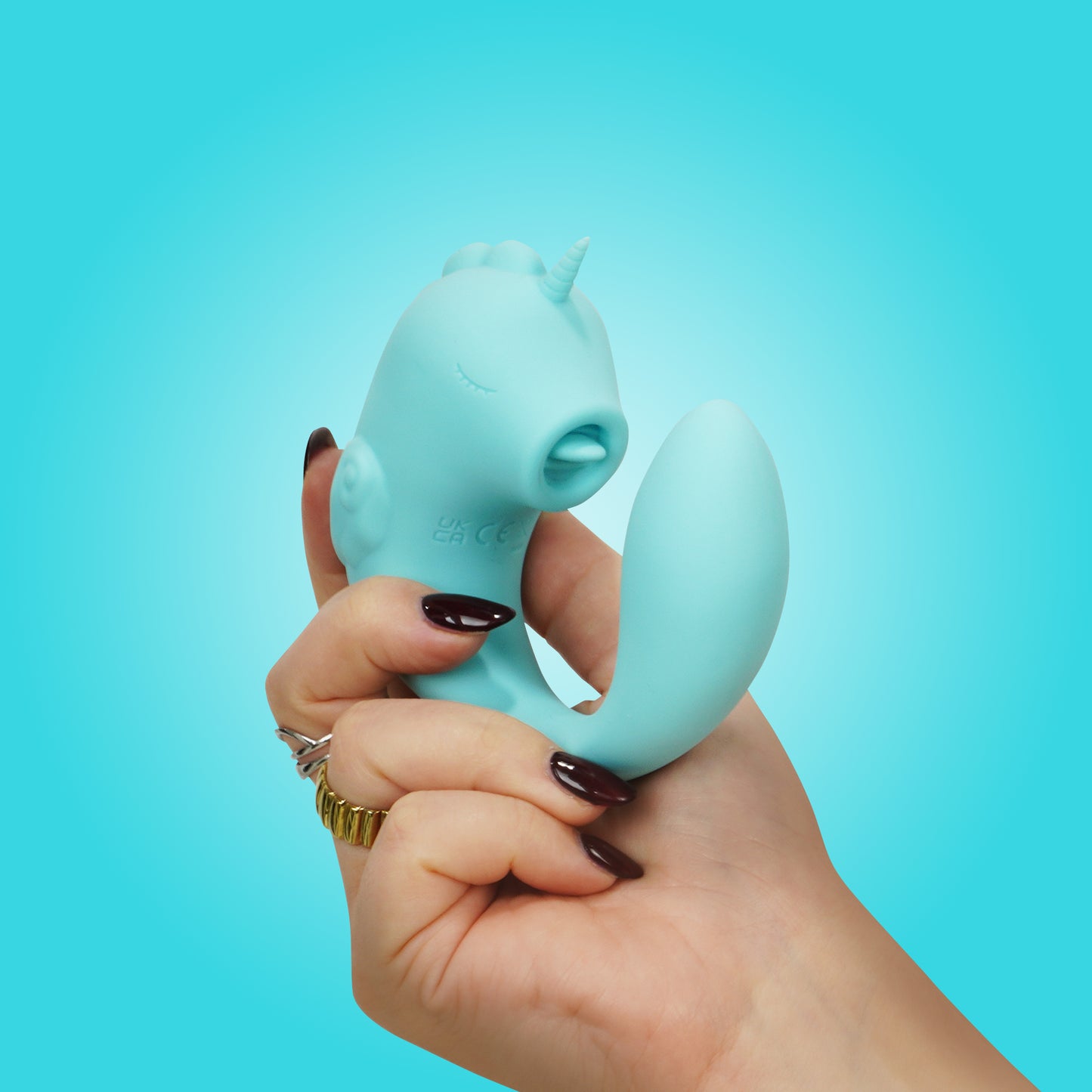 Ocean Peak Unihorn C-Horse front in natural c-shaped position in hand on a blue background