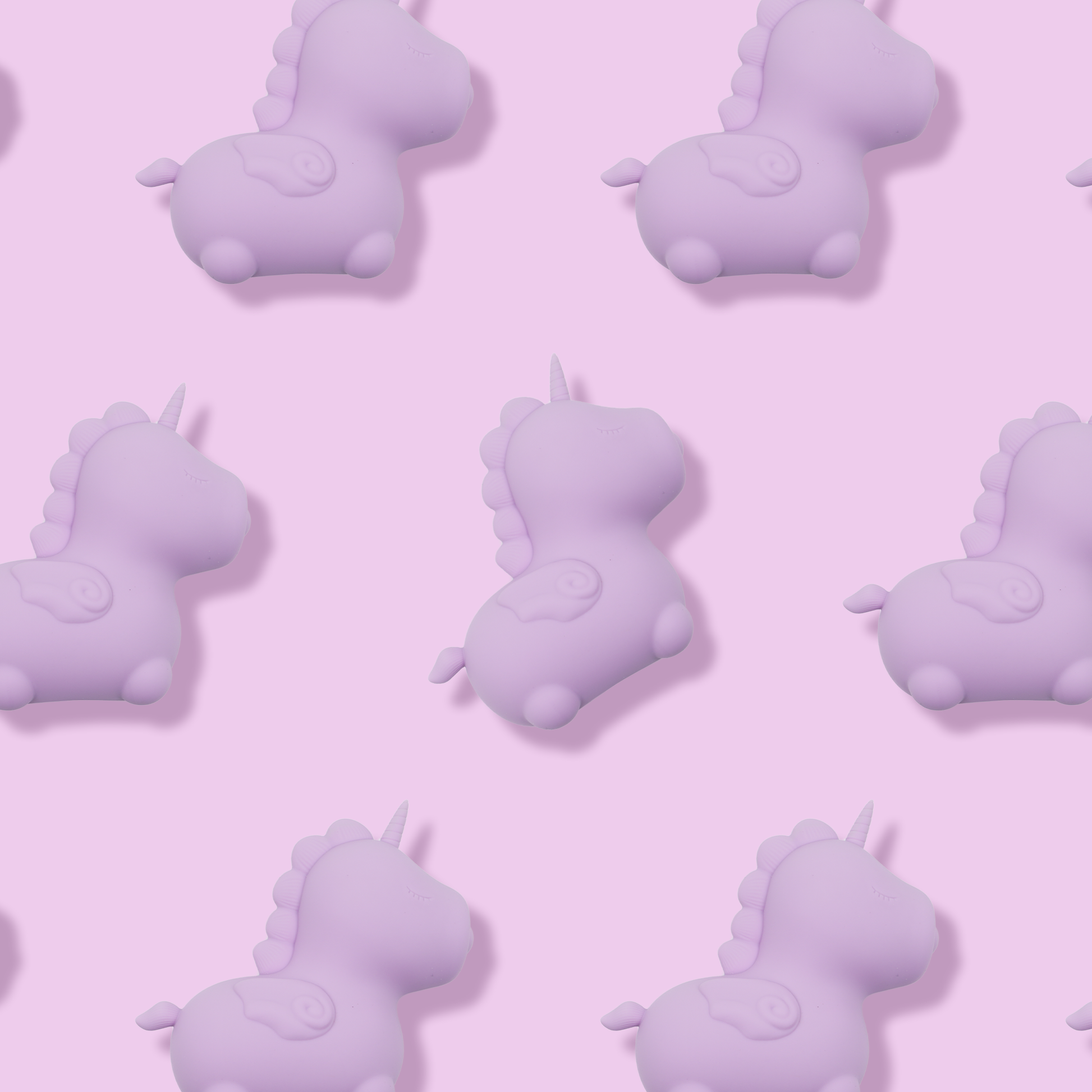 7 Karma Lilac Unihorn's, facing the right, spread out evenly on a light purple background