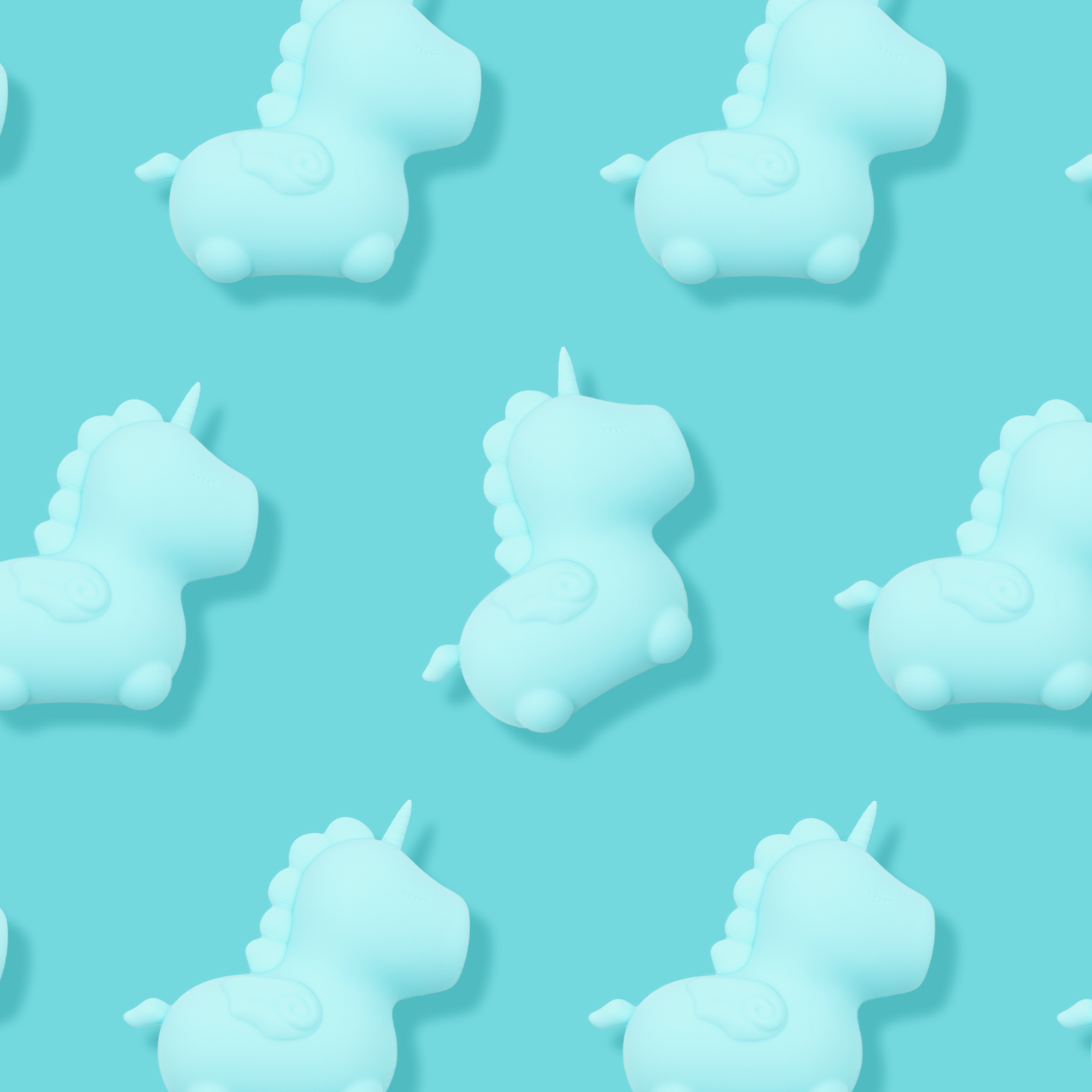 7 Bean Blossom clitoral vibrators facing the rights, spread out evenly on a blue background