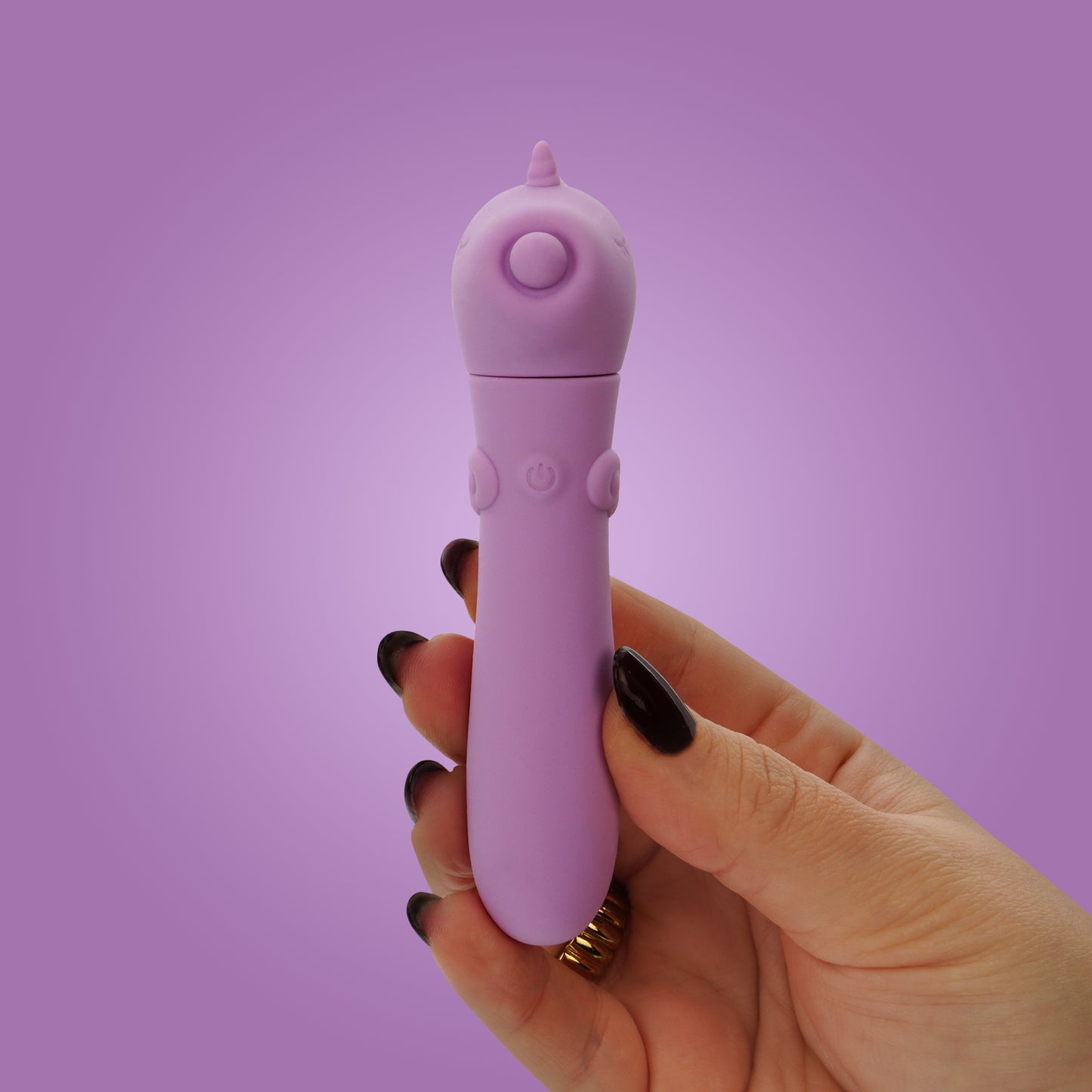 Hand holding Karma Lilac USB bullet vibrator on a purple background