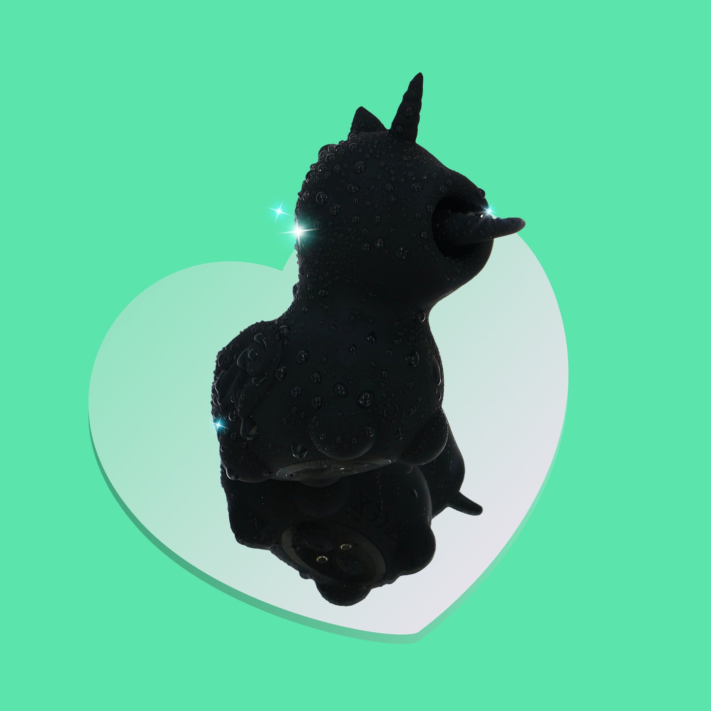 Wild Spirit clitoral vibrator covered in water droplets on a mirrored heart on a green background