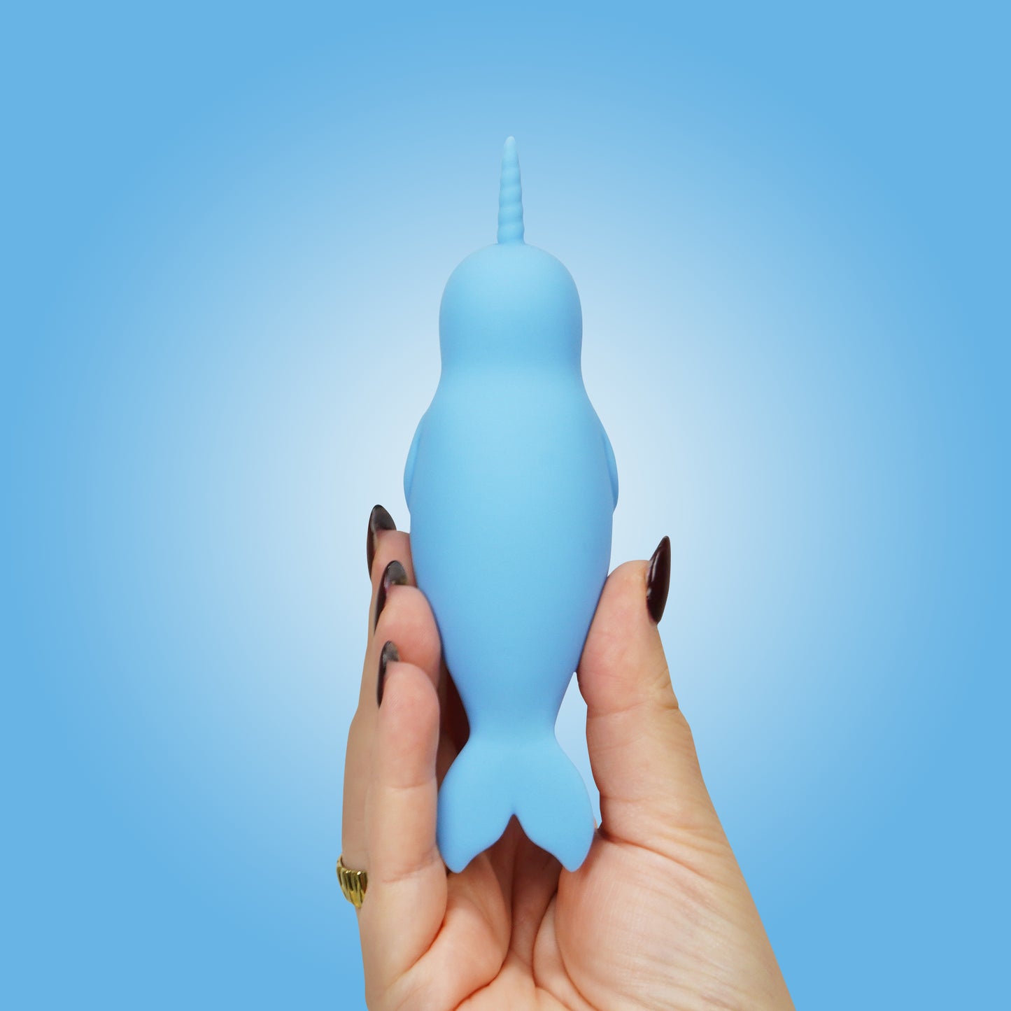 A top-down view of Neigh Mo Unihorn vibrator in a hand with a blue background