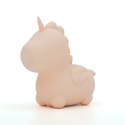 Baby pink Heart Throb Unihorn vibrator facing slightly left and stood on a plain white background 